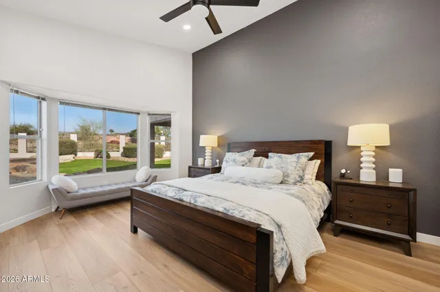 a bed room with a bed and a large window