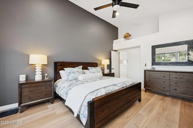 a bed room with a bed and a ceiling fan