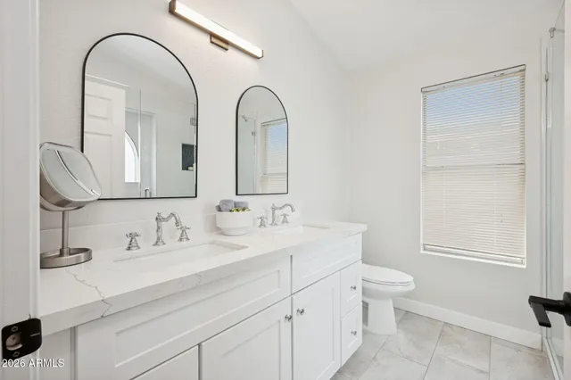 a bathroom with a double vanity sink and a mirror