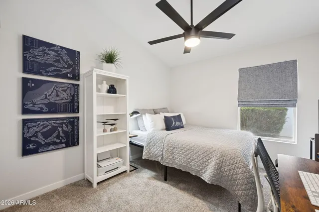 a bedroom with a bed a couch and a window