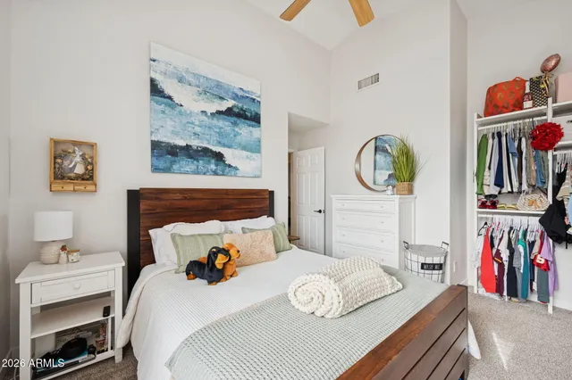 a bedroom with a bed wall painting and a window