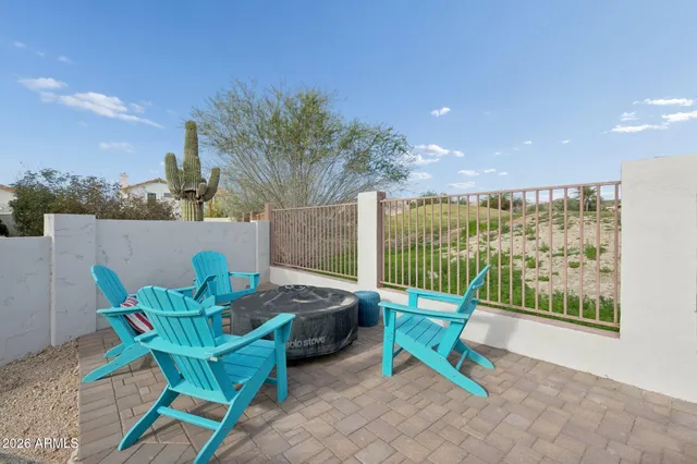 a view of a chairs and table in patio