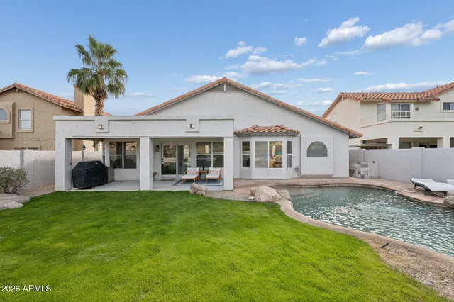 a front view of a house with a garden and patio