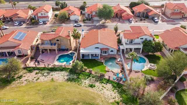 an aerial view of multiple houses with yard