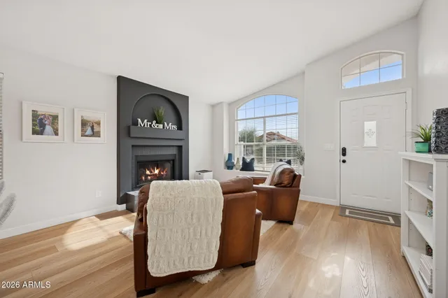 a living room with furniture and a fireplace