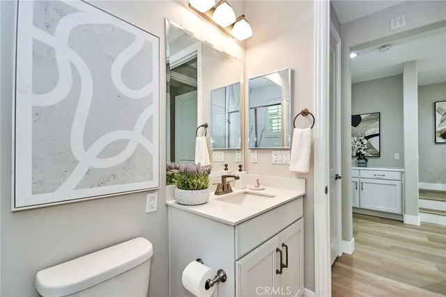 a bathroom with a sink vanity mirror and toilet