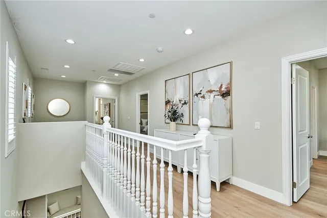 a view of a hallway with wooden floor and entryway