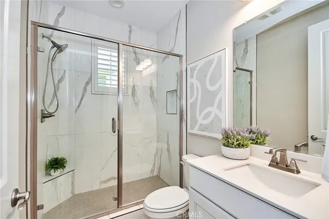 a bathroom with a sink shower and a mirror