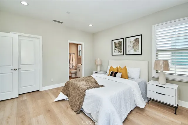 a bedroom with a bed and wooden floor