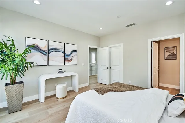 a bedroom with a bed and a potted plant