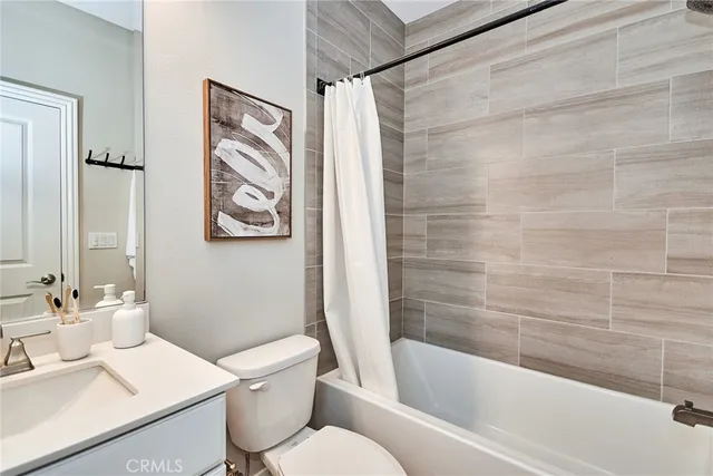 a bathroom with a toilet a sink and bathtub