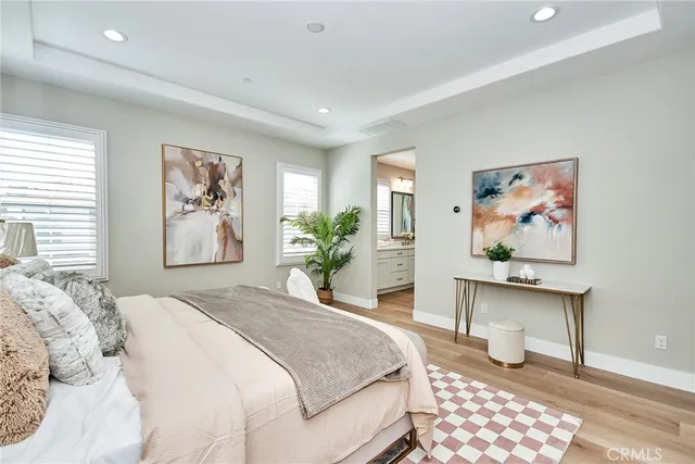 a bedroom with a bed and a painting on the wall