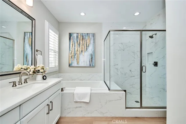 a bathroom with a double vanity sink toilet mirror and shower