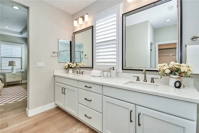 a bathroom with double sink and a mirror