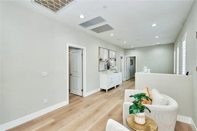 a living room with furniture and flowers