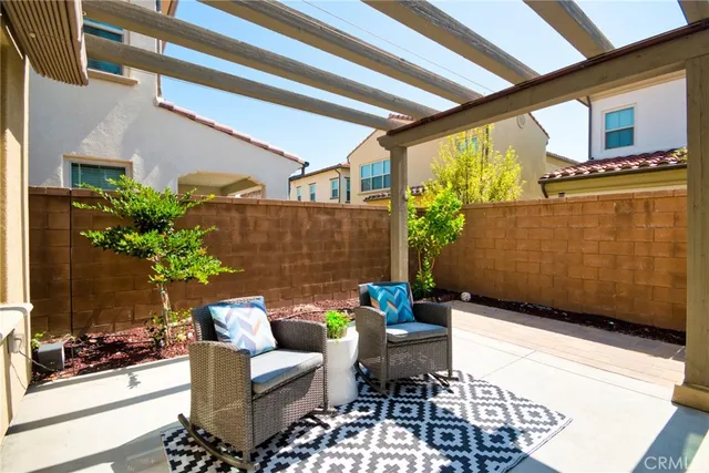 a view of a patio with table and chairs and potted plants