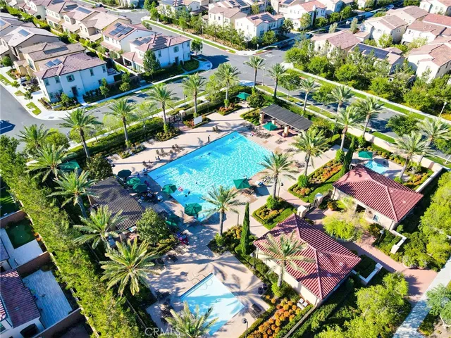 an aerial view of residential houses with outdoor space and trees all around