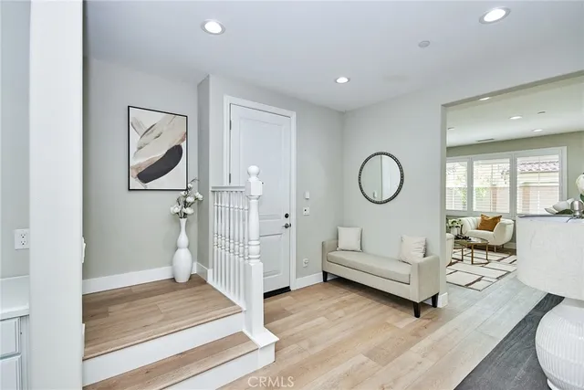 a living room with furniture a rug and white walls