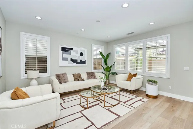 a living room with furniture and floor to ceiling windows