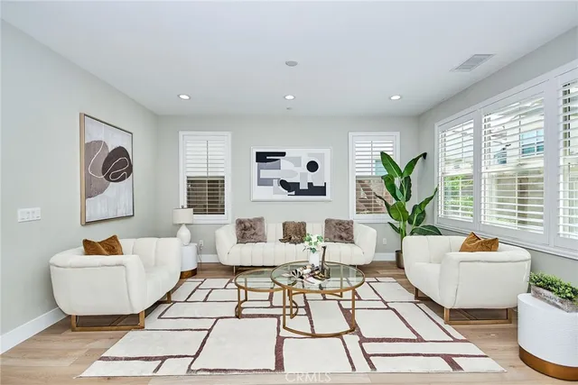 a living room with furniture and a potted plant