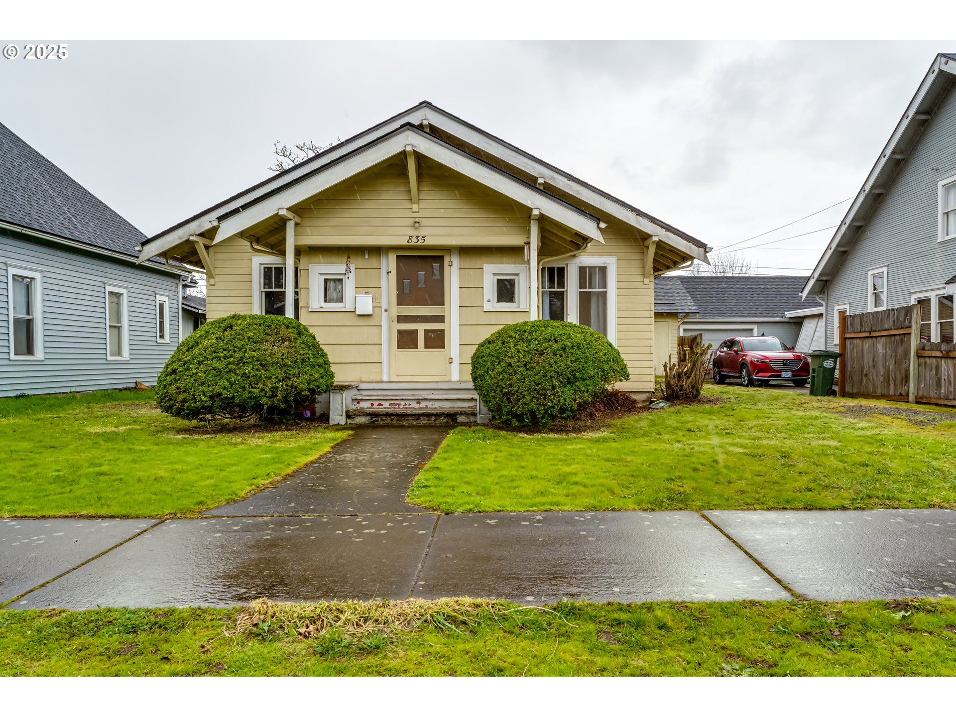 835 Maple Street Junction City, OR 97448 - Photo 2 of 29 a front view of a house with a yard and garage