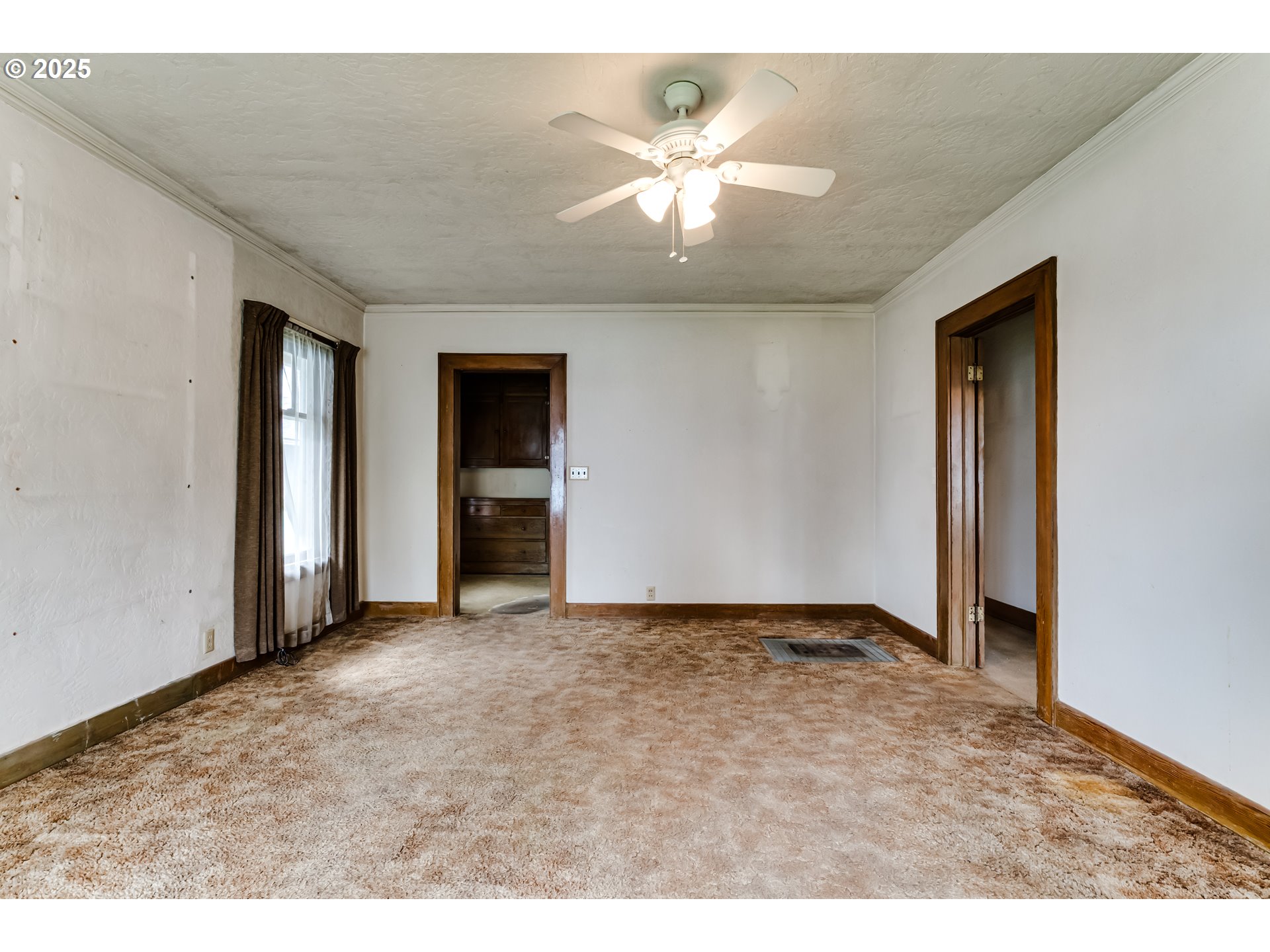 835 Maple Street Junction City, OR 97448 - Photo 6 of 29 a view of an empty room with a ceiling fan