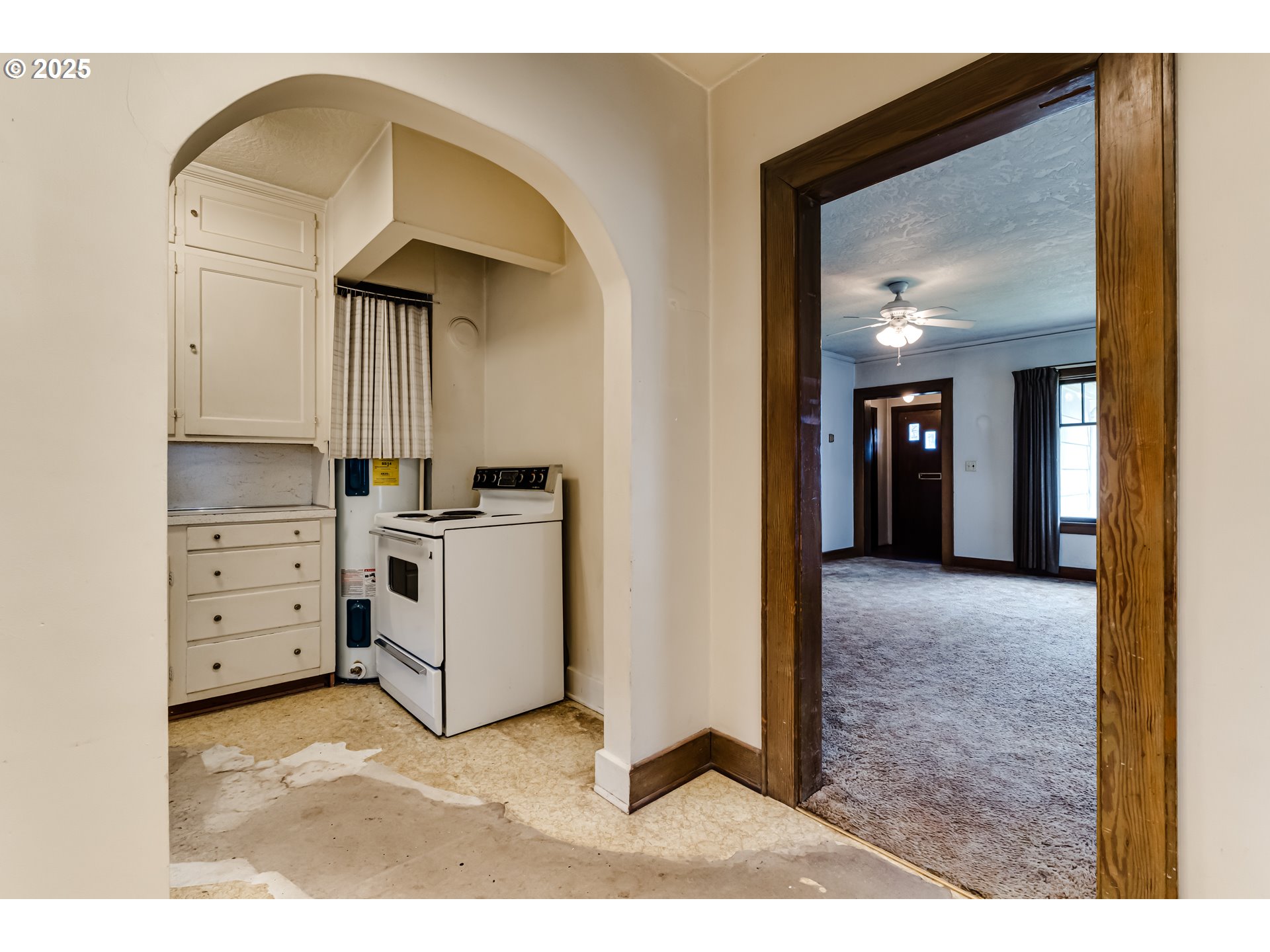 835 Maple Street Junction City, OR 97448 - Photo 9 of 29 a view of kitchen and hallway with chandelier