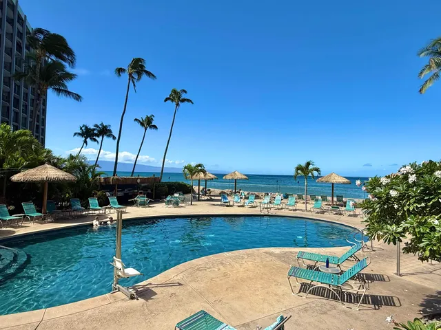 a view of a swimming pool with a table and chairs