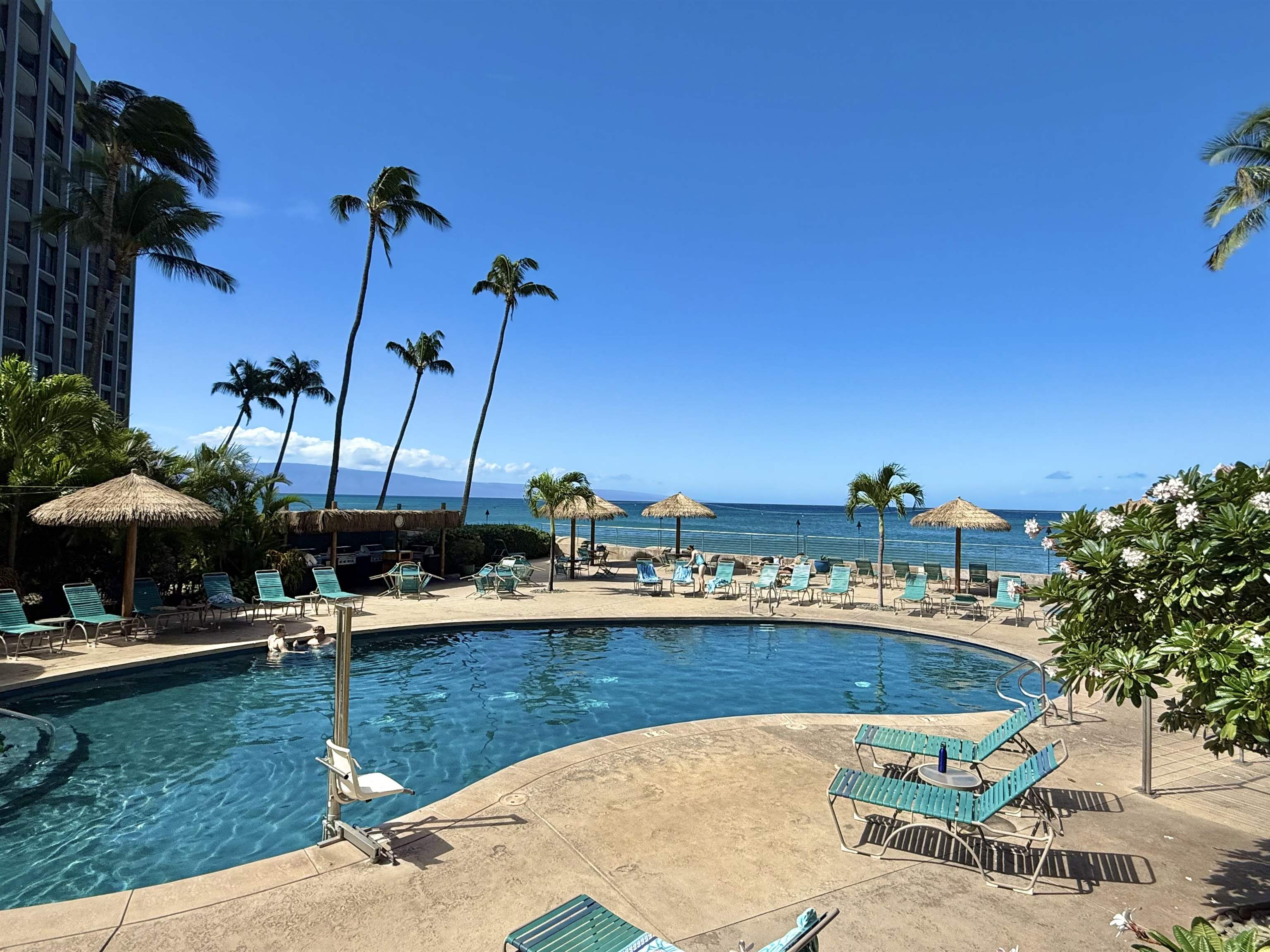 4365 Lower Honoapiilani Road, Unit 801 Lahaina, HI 96761 - Photo 19 of 24 a view of a lake with a table and chairs