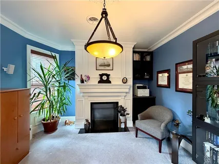 a living room with furniture and a fireplace