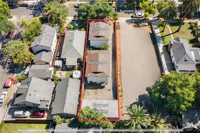 an aerial view of residential houses with outdoor space and parking