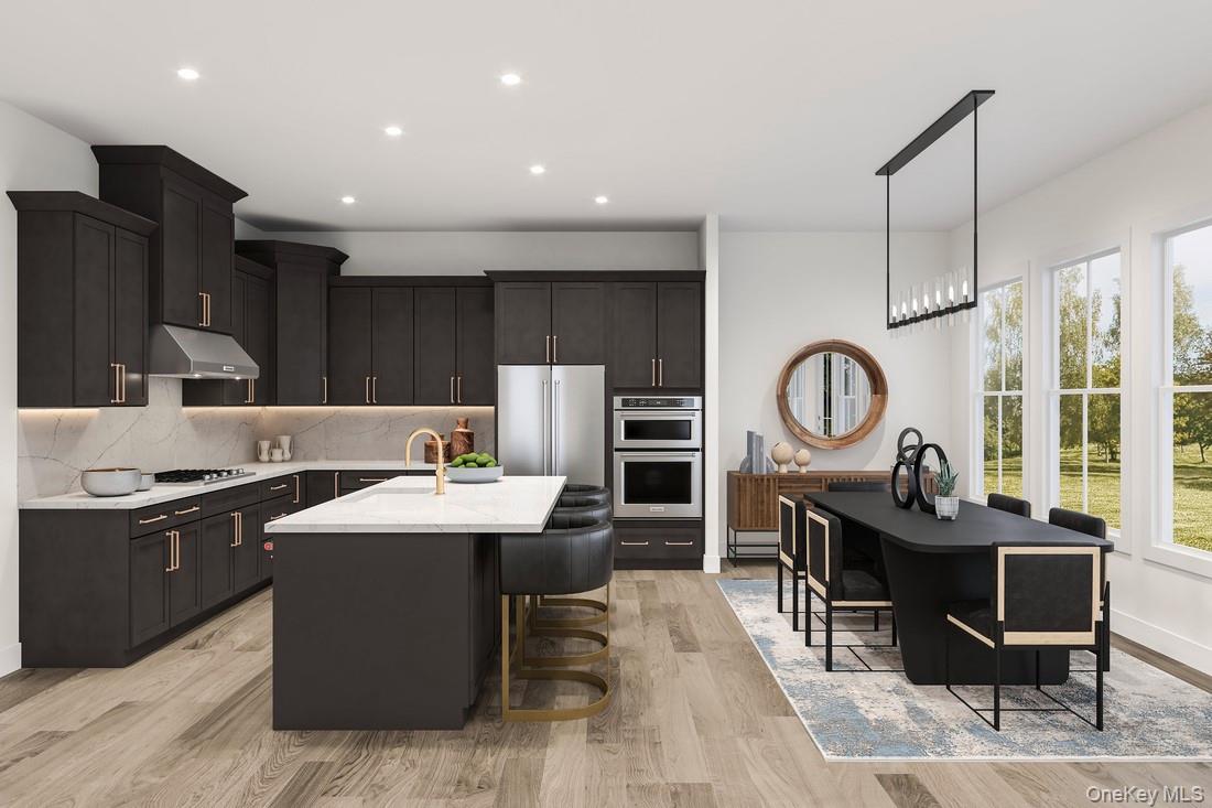 15 Marker Ridge, Unit 16 Irvington, NY 10533 - Photo 2 of 4 a kitchen with kitchen island granite countertop a sink a stove a refrigerator cabinets a dining table and chairs