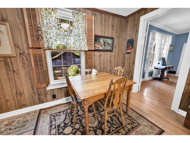 245 Cromer Road Williamston, SC 29697 - Photo 6 of 27 A quaint dining area with wood paneling and a large window offers a bright, inviting space.
