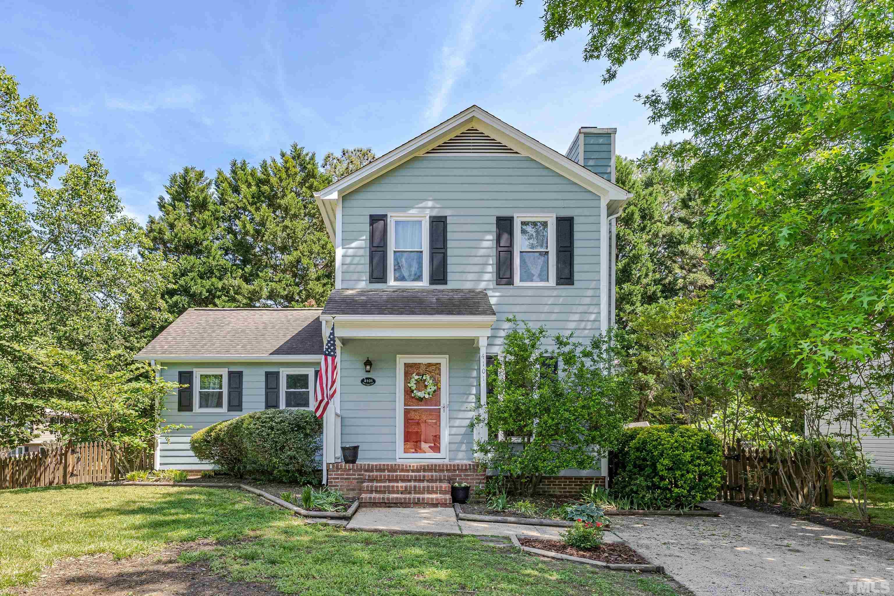 4101 Olde Coach Road Durham, NC 27707 - Photo 1 of 21 a front view of a house with a garden