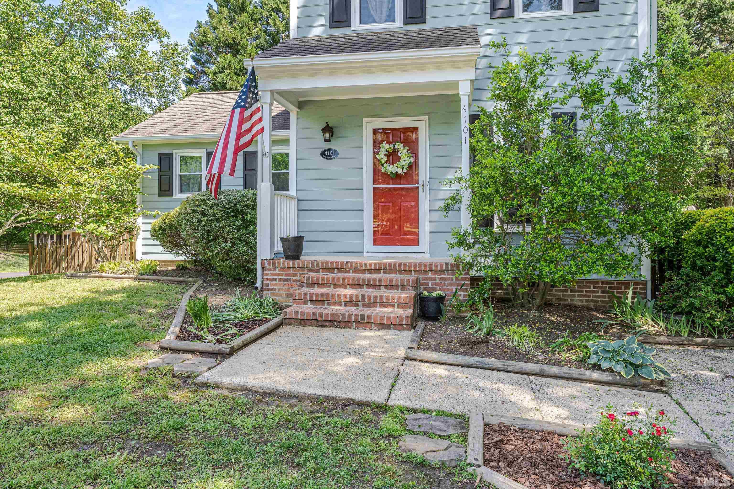 4101 Olde Coach Road Durham, NC 27707 - Photo 3 of 21 a front view of a house with garden