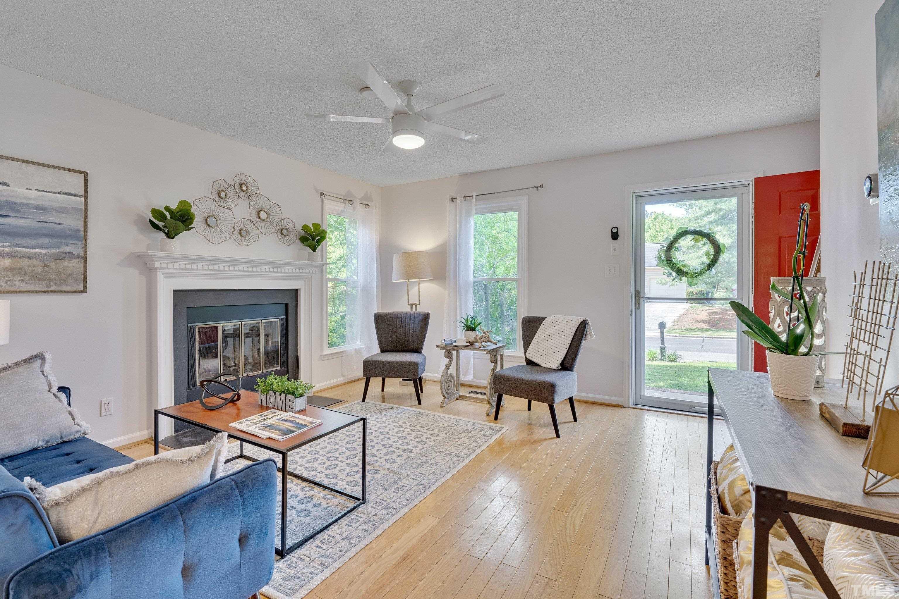 4101 Olde Coach Road Durham, NC 27707 - Photo 4 of 21 a living room with furniture a fireplace and a table