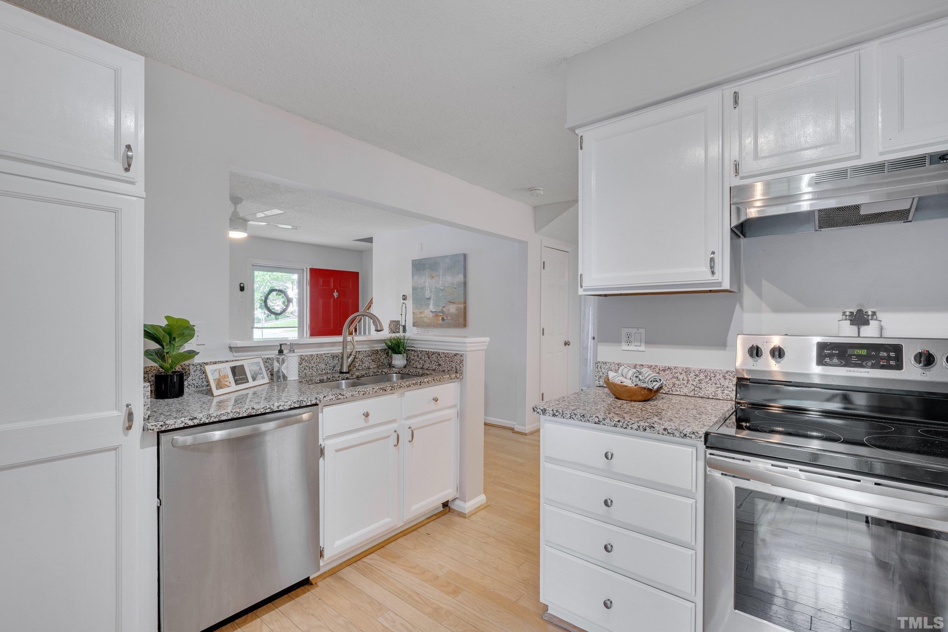 4101 Olde Coach Road Durham, NC 27707 - Photo 6 of 21 a kitchen with white cabinets and appliances