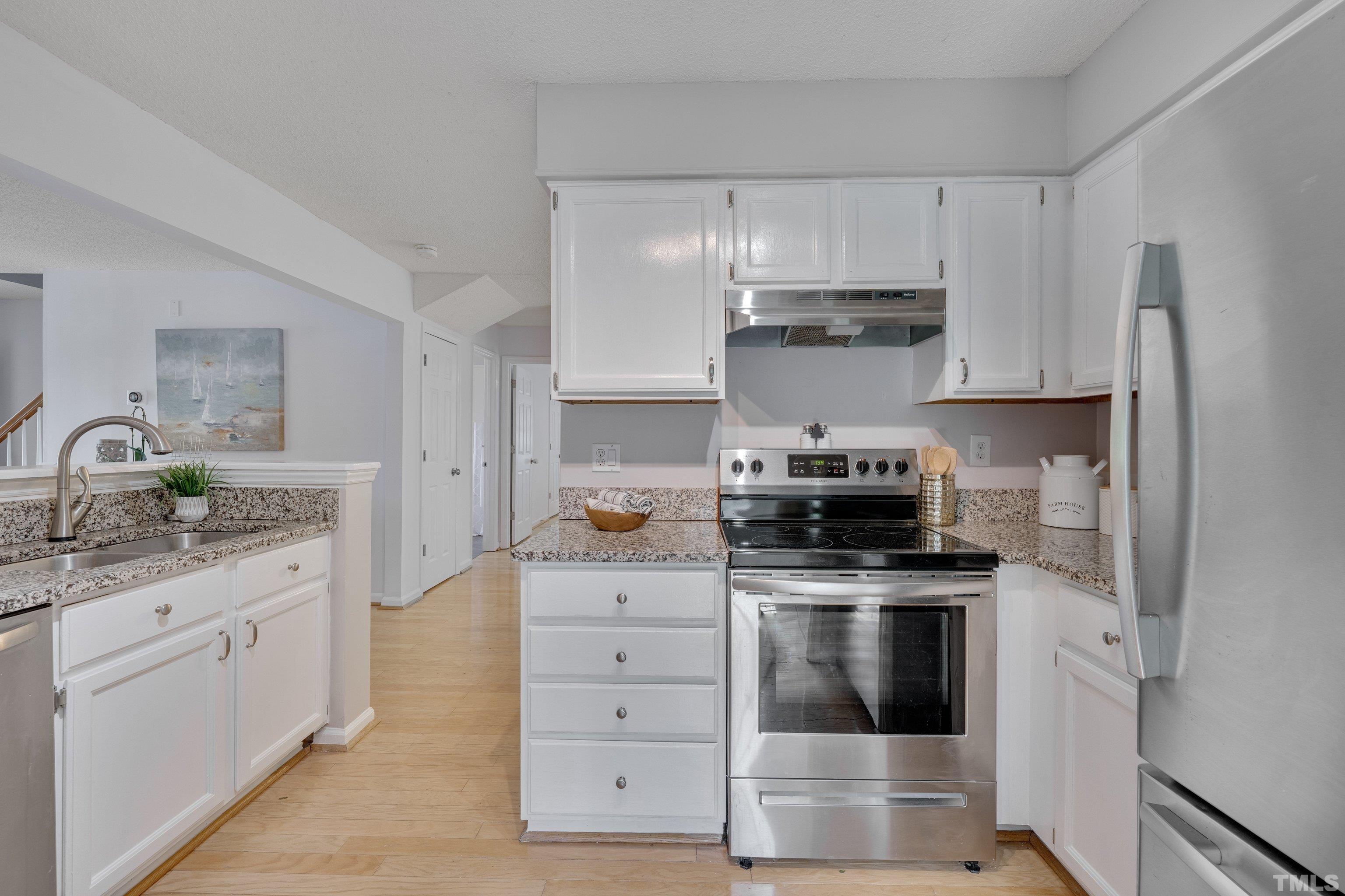 4101 Olde Coach Road Durham, NC 27707 - Photo 7 of 21 a kitchen with granite countertop white cabinets and stainless steel appliances
