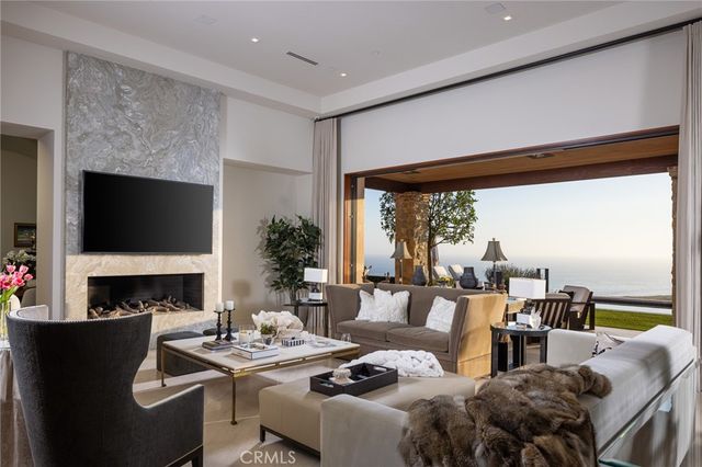 a living room with furniture fireplace and a large window