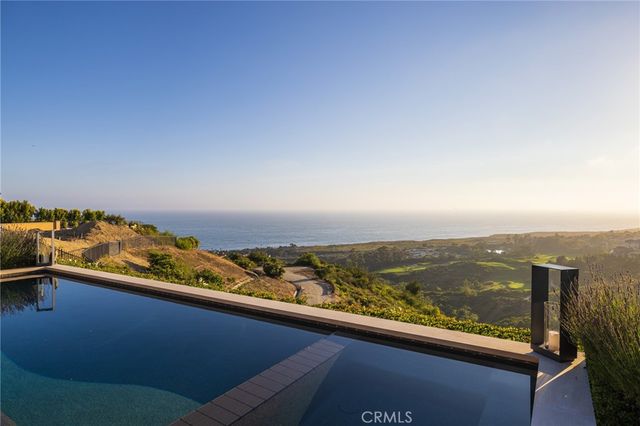 an aerial view of ocean and residential houses