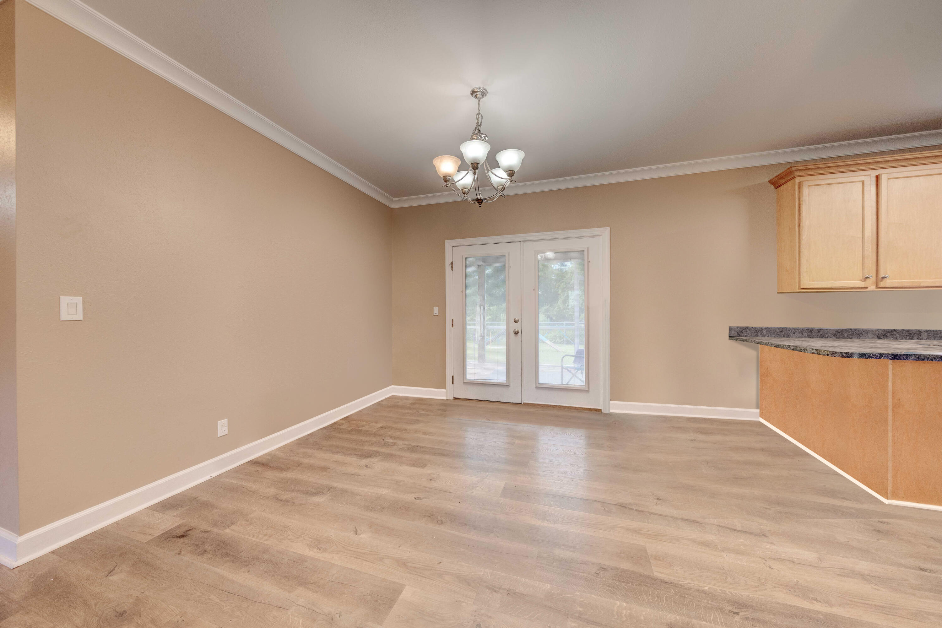 700 Timber Ridge Court Eastpoint, FL 32328 - Photo 11 of 20 a view of an empty room with window and wooden floor