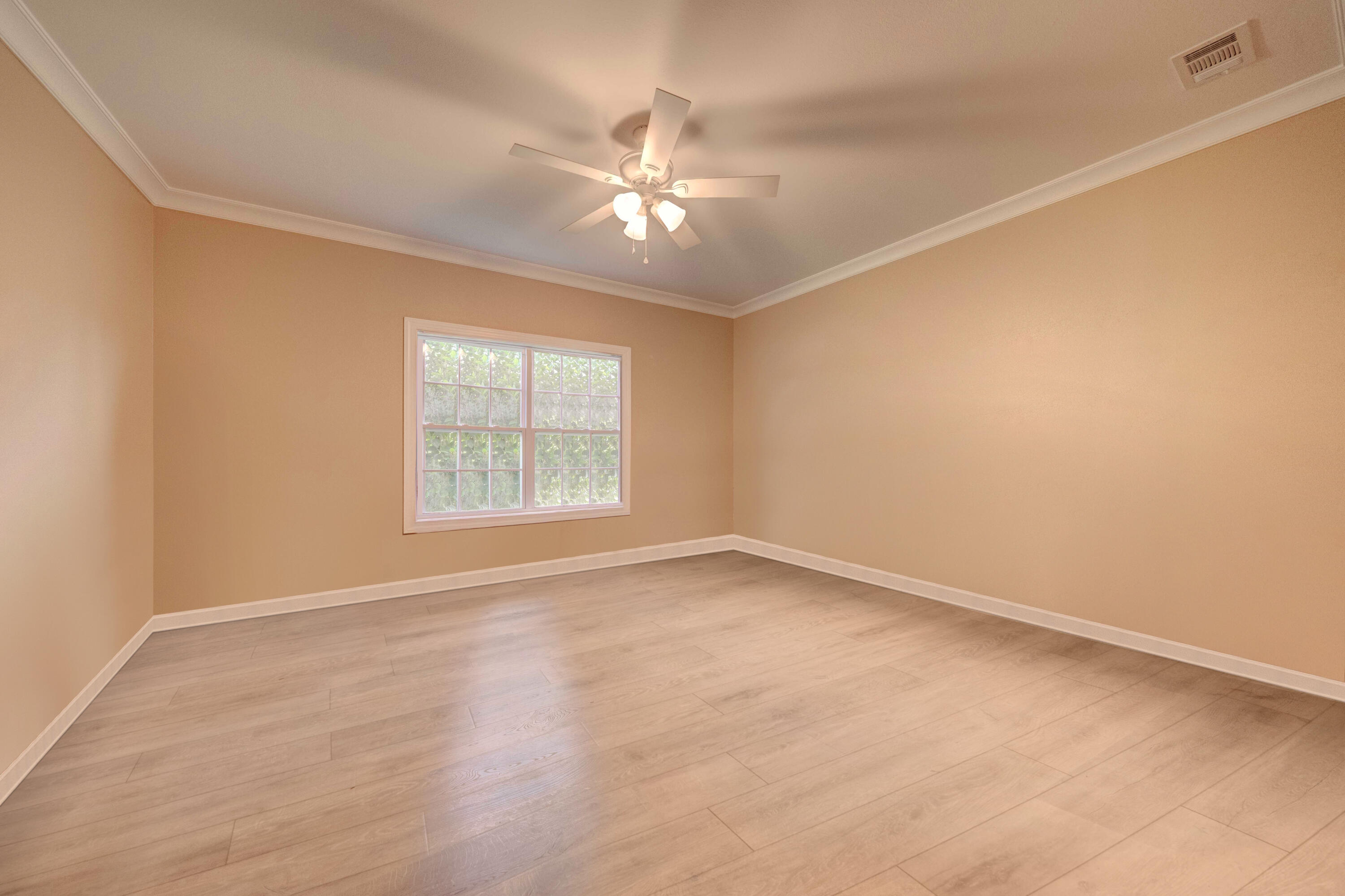 700 Timber Ridge Court Eastpoint, FL 32328 - Photo 13 of 20 an empty room with a window and ceiling fan