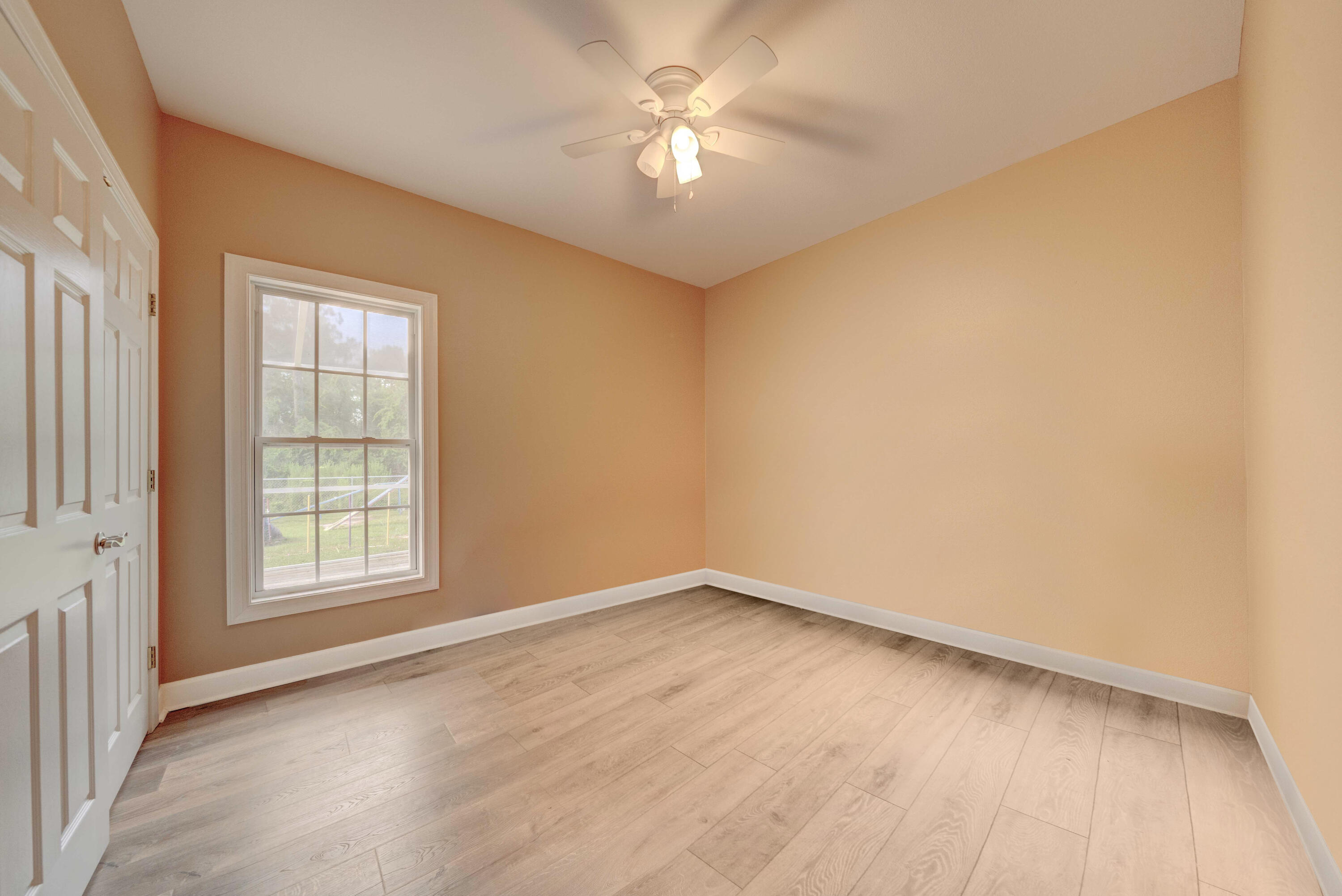 700 Timber Ridge Court Eastpoint, FL 32328 - Photo 15 of 20 an empty room with windows and fan