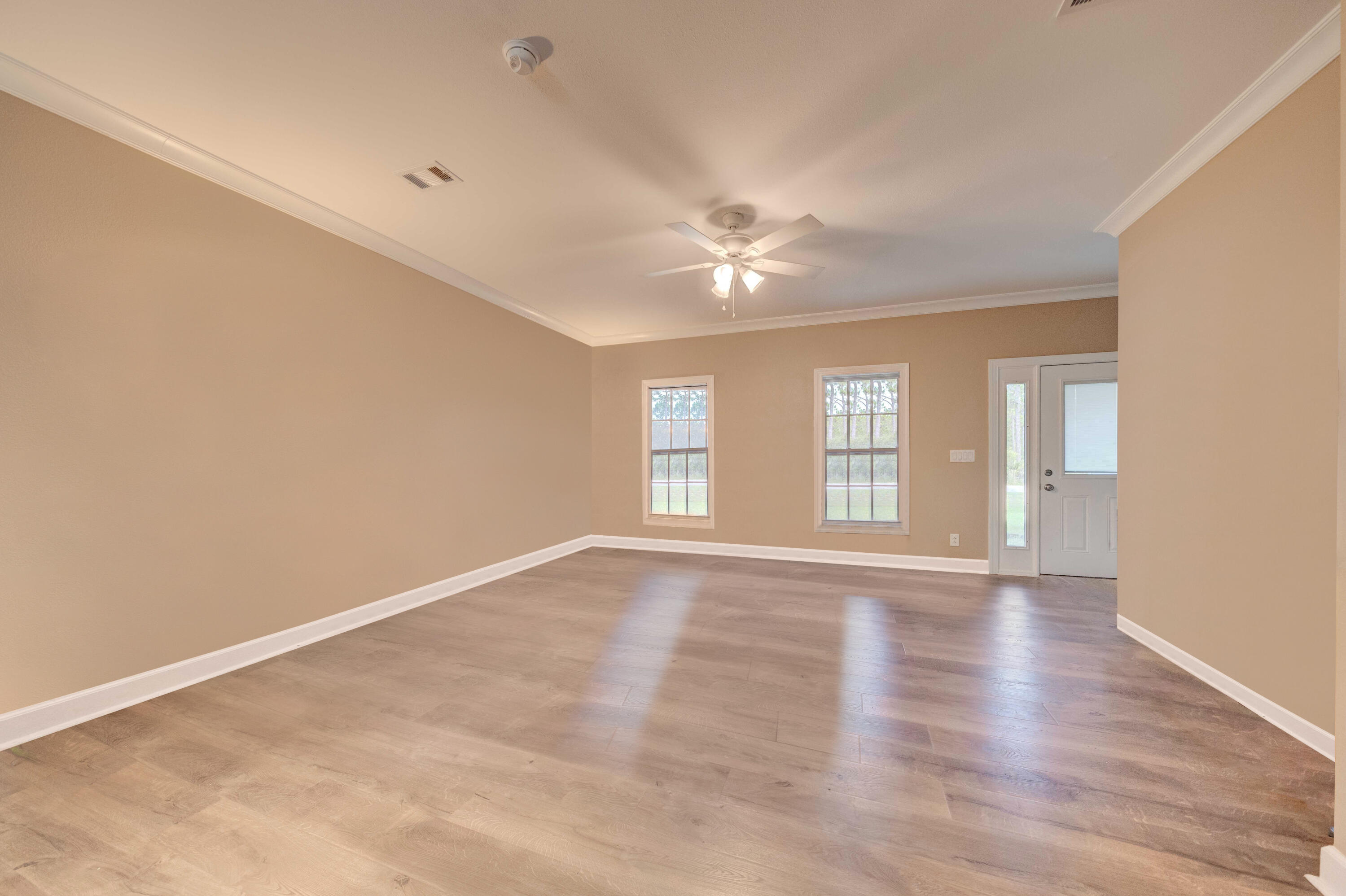 700 Timber Ridge Court Eastpoint, FL 32328 - Photo 5 of 20 wooden floor in an empty room with a window