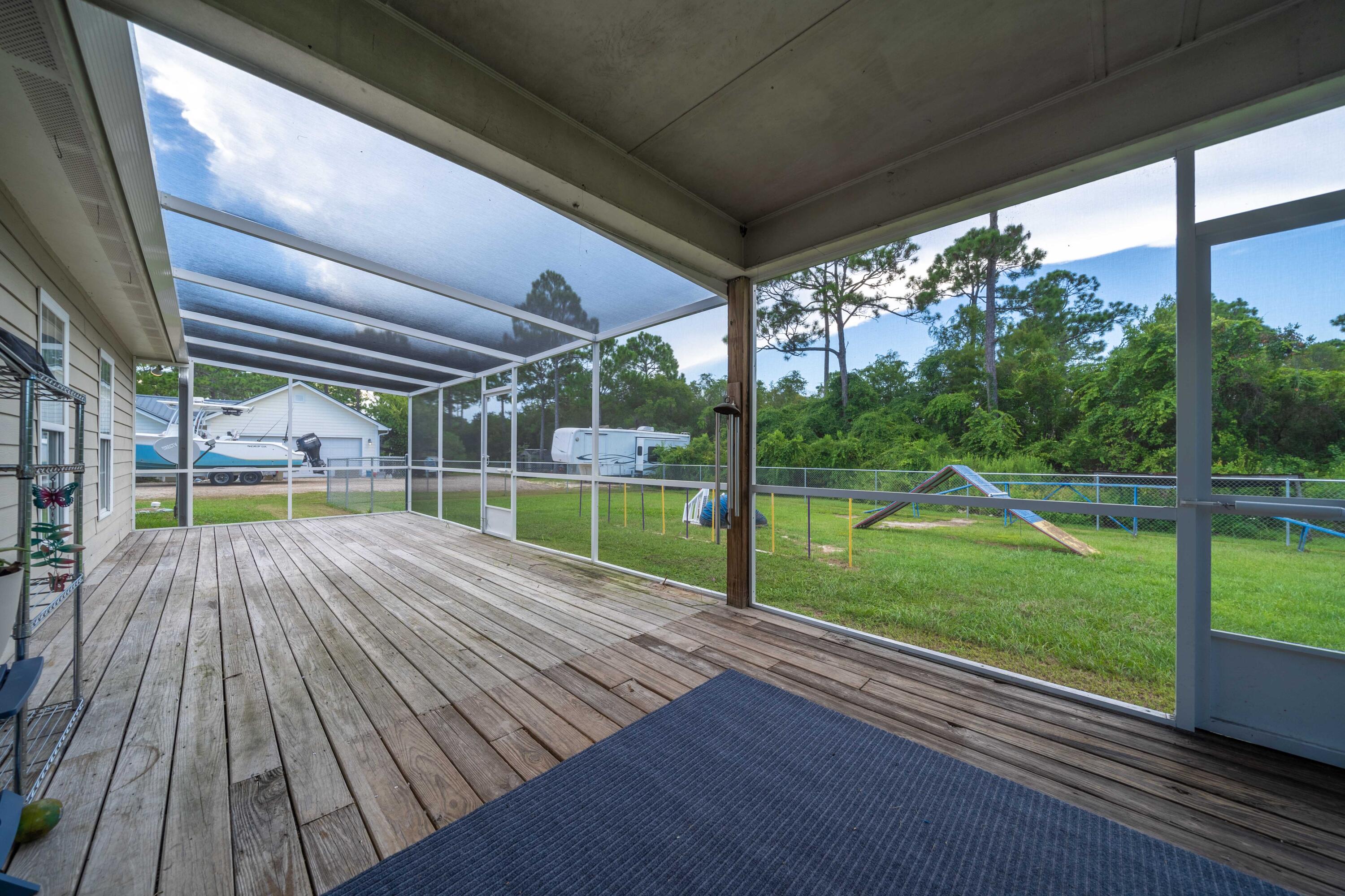 700 Timber Ridge Court Eastpoint, FL 32328 - Photo 6 of 20 a view of a deck with wooden floor and yard