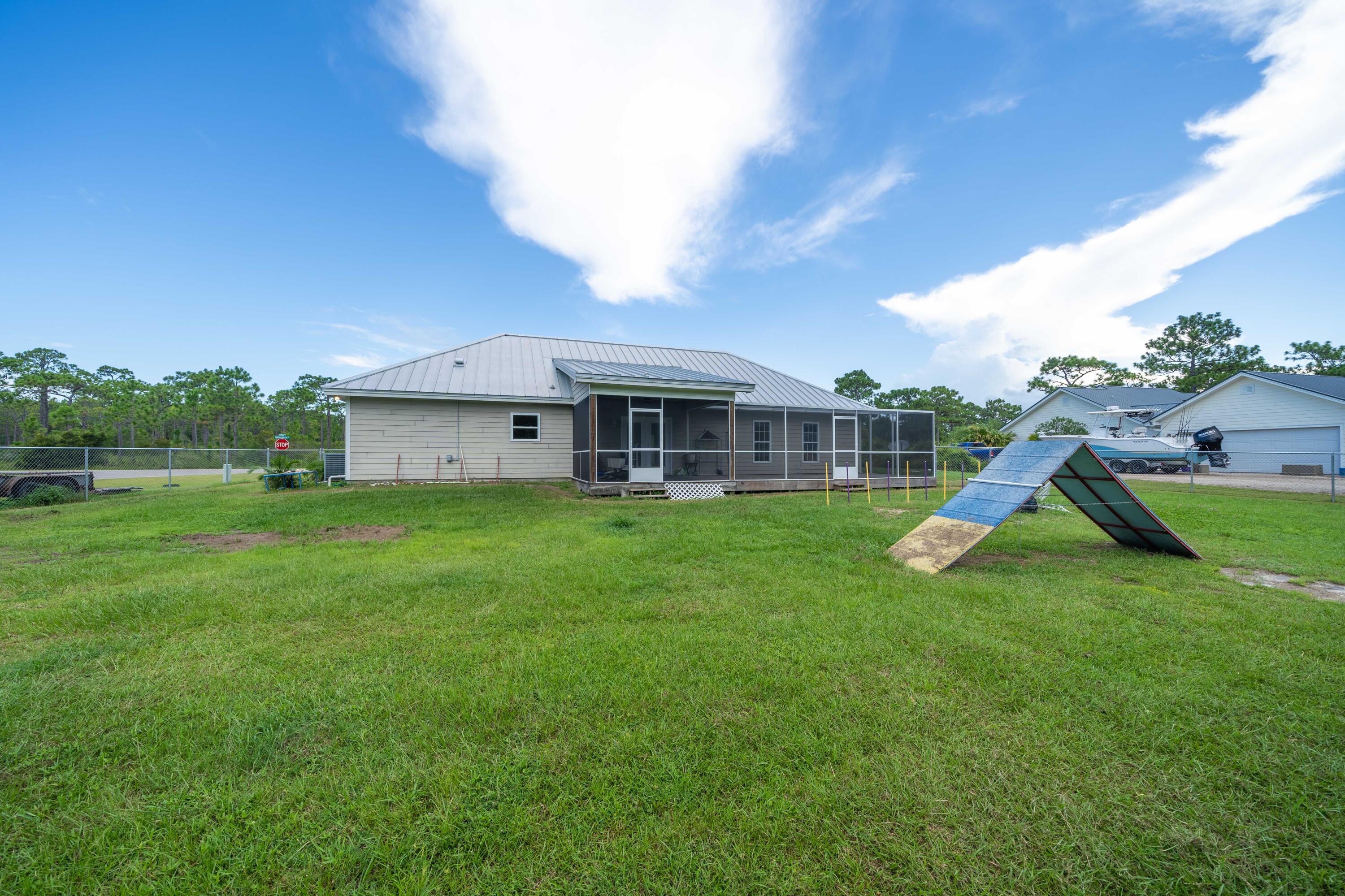 700 Timber Ridge Court Eastpoint, FL 32328 - Photo 7 of 20 a view of a house with a backyard