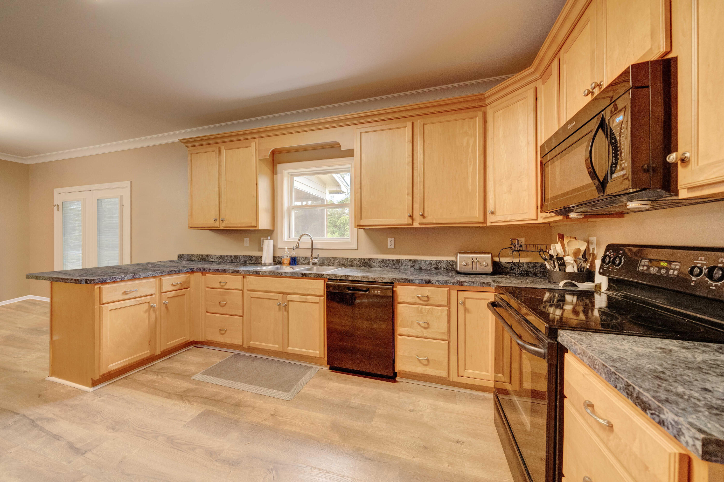 700 Timber Ridge Court Eastpoint, FL 32328 - Photo 10 of 20 a kitchen with stainless steel appliances granite countertop a stove a sink and a microwave