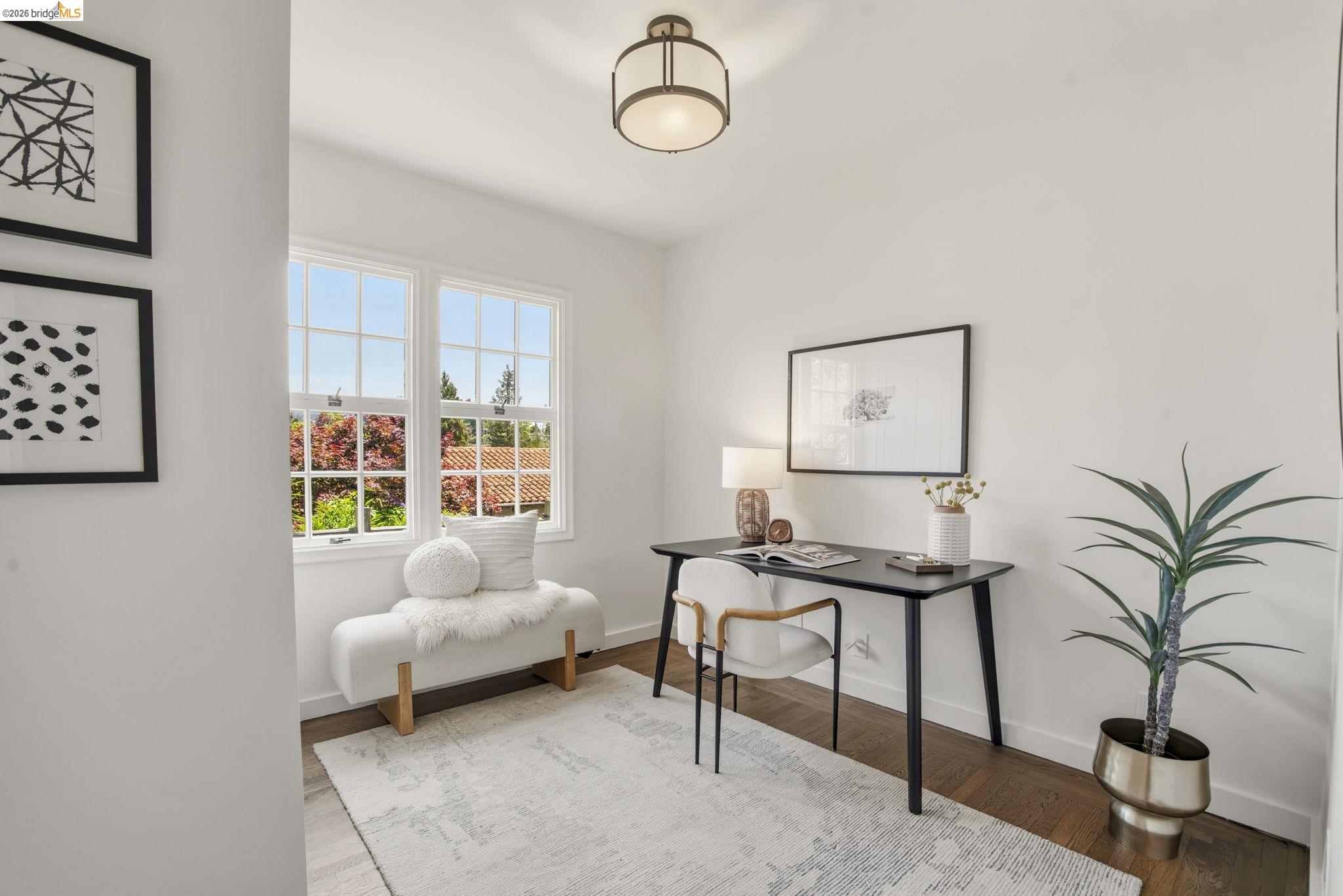 1087 Hubert Road Oakland, CA 94610 - Photo 35 of 67 Bright room featuring dual pane windows, wood-finish flooring, a contemporary ceiling light fixture, and white wall finishes