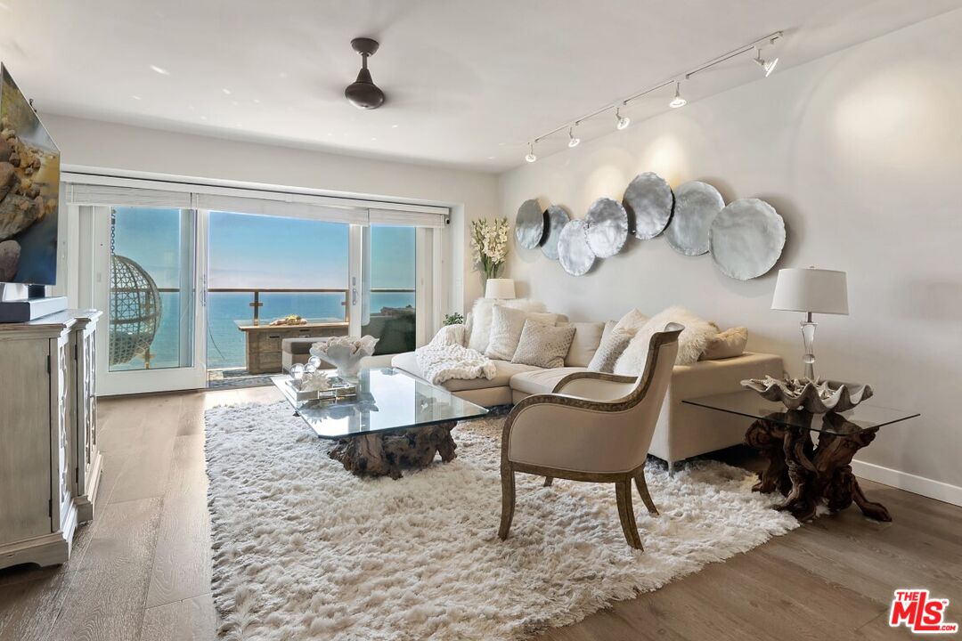 18147 Coastline Drive, Unit 3 Malibu, CA 90265 - Photo 1 of 40 a living room with furniture and a table