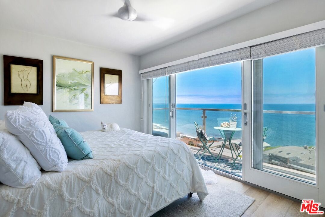 18147 Coastline Drive, Unit 3 Malibu, CA 90265 - Photo 17 of 40 a large bedroom with a bed and glass door